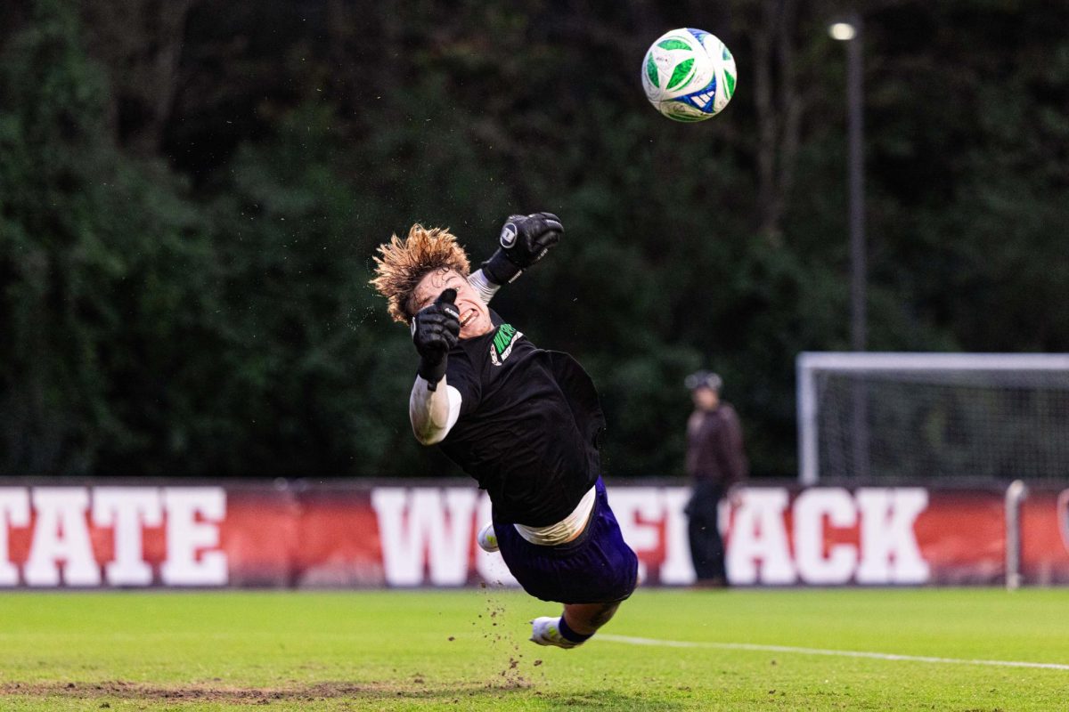 Senior goalkeeper Logan Erb dives to stop the ball during warmups before their matchup against Clemson in Dail Soccer Stadium on Friday, Oct. 10, 2025. NC State defeated Clemson 1-0.