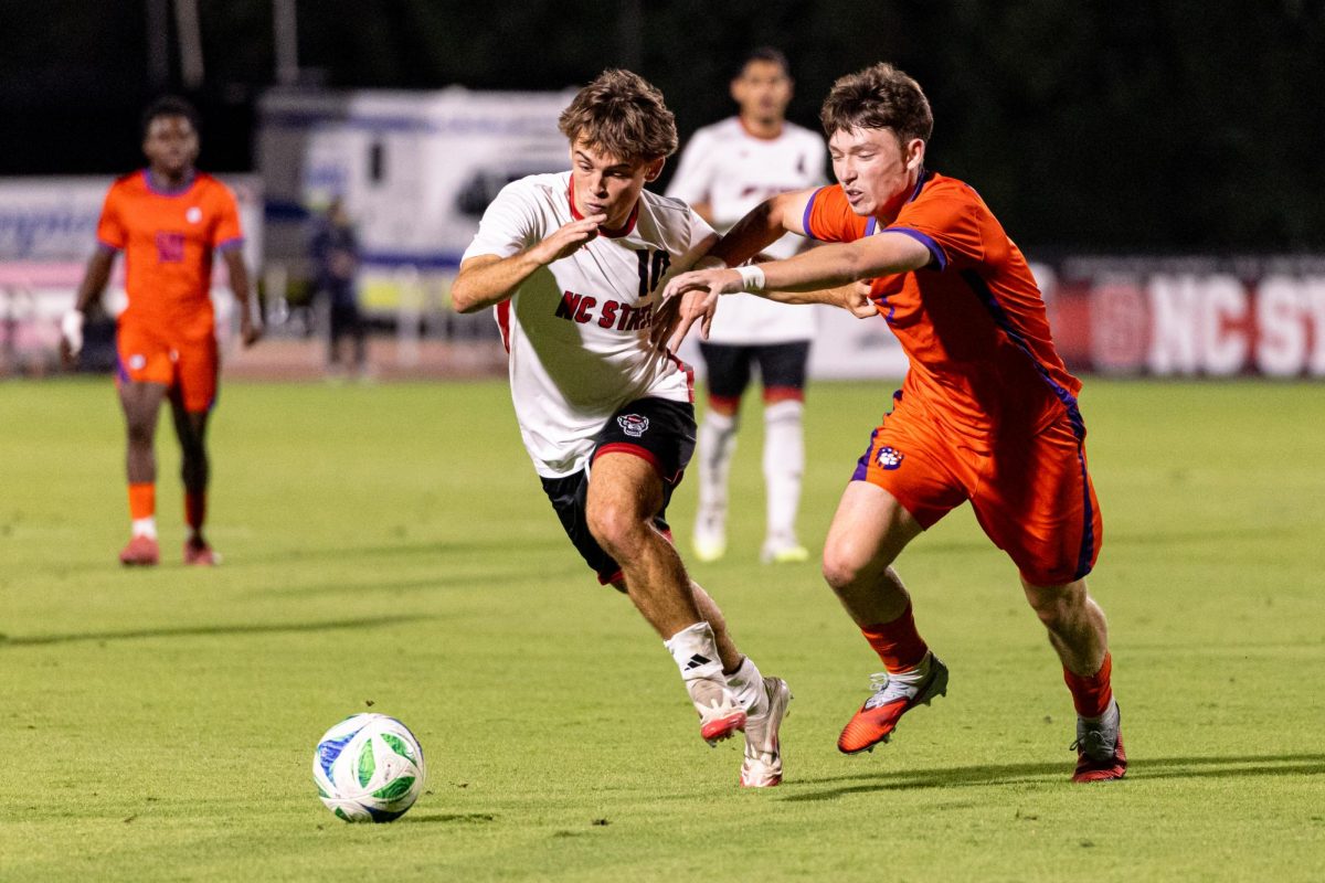 Senior midfielder Taig Healy fights off a defender during the game against Clemson in Dail Soccer Stadium on Friday, Oct. 10, 2025. Healy attempted one shot on the goal. NC State defeated Clemson 1-0.