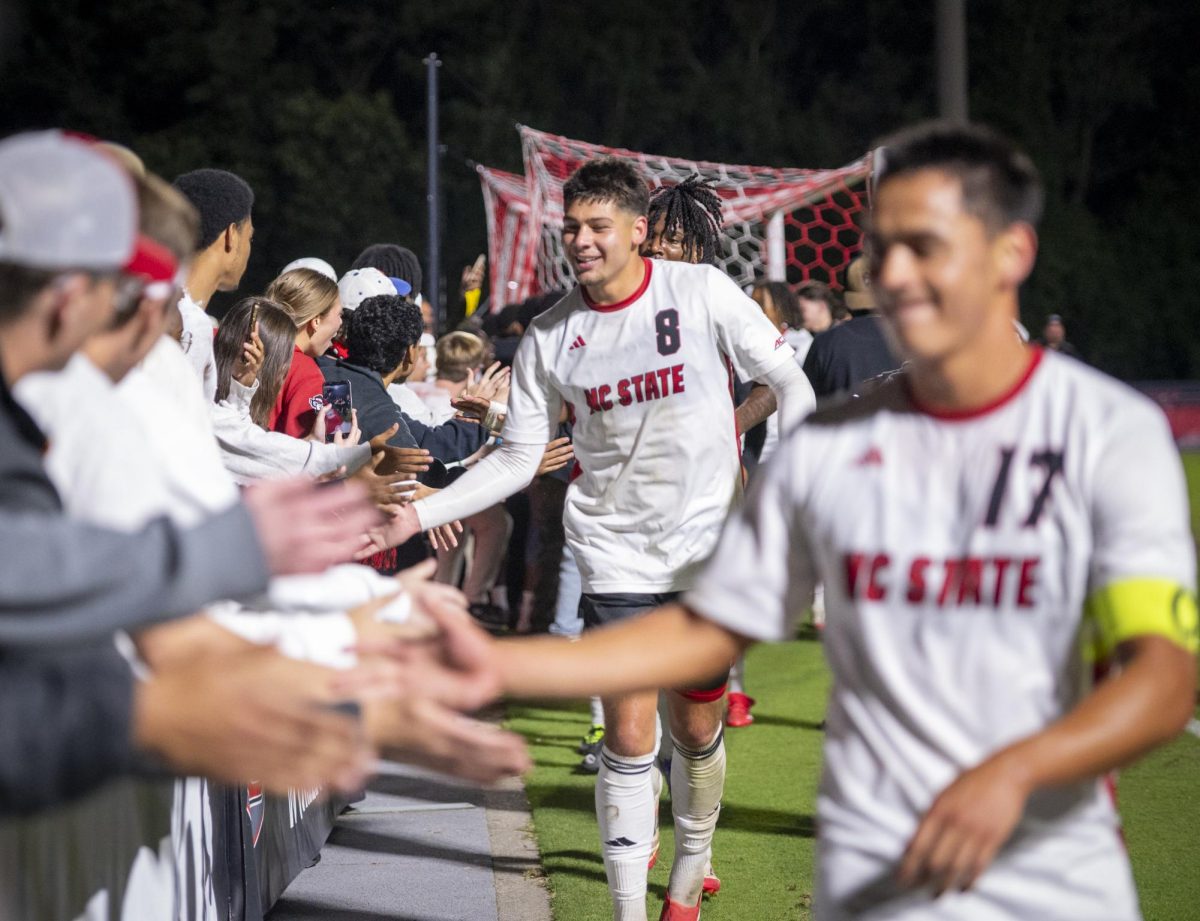 Senior midfielder Justin Mclean high-fives fans after the game against Clemson in Dail Soccer Stadium on Friday, Oct. 10, 2025. Mclean attempted 1 shot on the goal. The Wolfpack defeated the Tigers 1-0. 