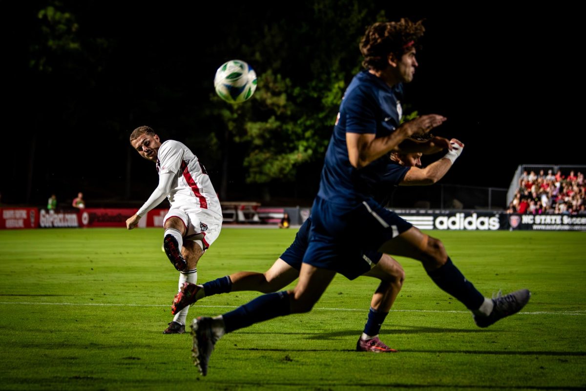 Senior midfielder Drew Lovelace shoots the ball during the game against Virginia in Dail Soccer Stadium on Sunday, Oct. 5, 2025. The Cavaliers defeated the Wolfpack 1-0.