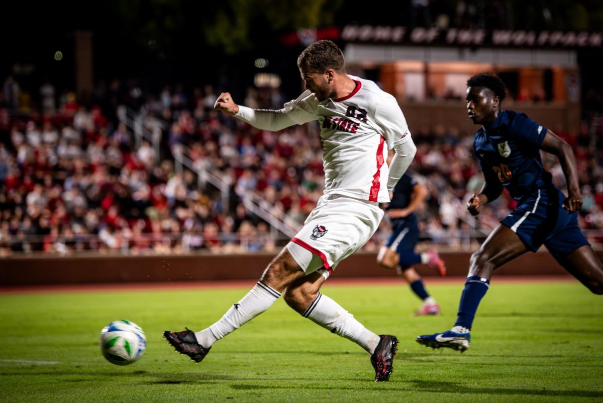 Senior midfielder Drew Lovelace shoots the ball during the game against Virginia in Dail Soccer Stadium on Sunday, Oct. 5, 2025. The Cavaliers defeated the Wolfpack 1-0.