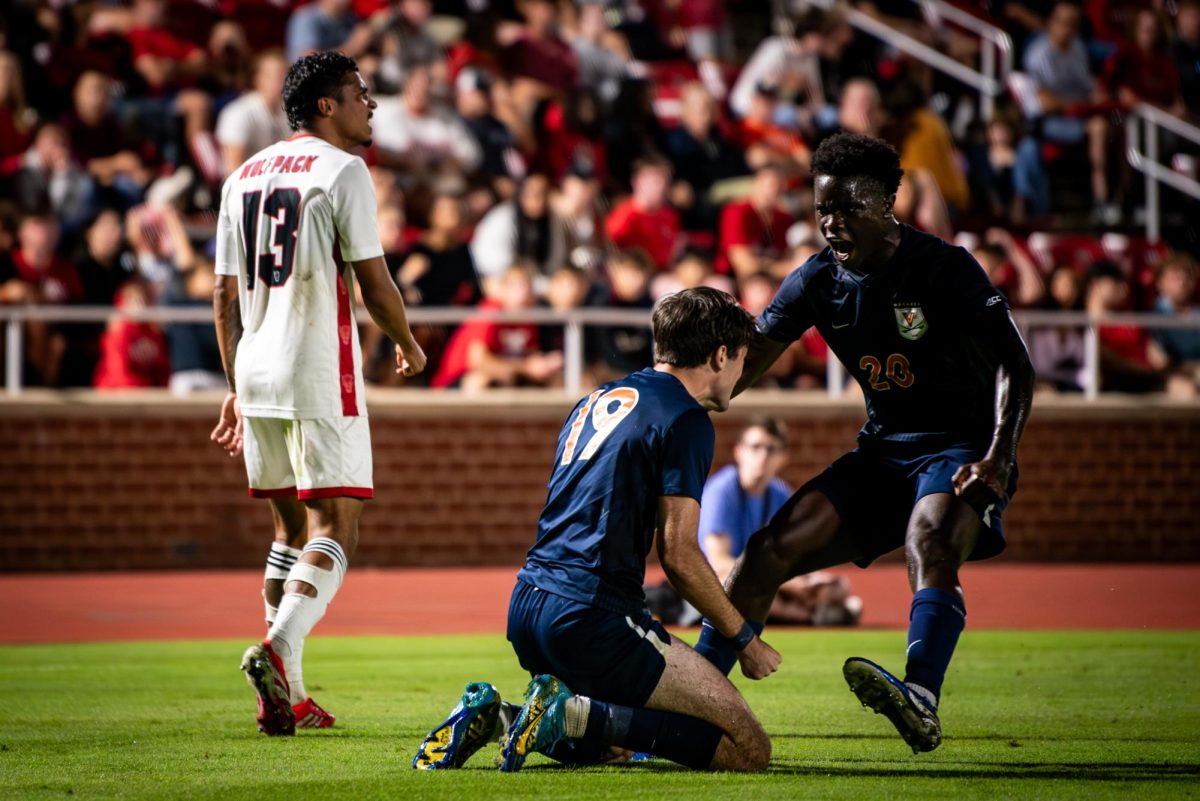 Virginia players celebrate as senior defenseman Calem Tommy walks off after receiving a yellow card during the game against Virginia in Dail Soccer Stadium on Sunday, Oct. 5, 2025. The Cavaliers defeated the Wolfpack 1-0.