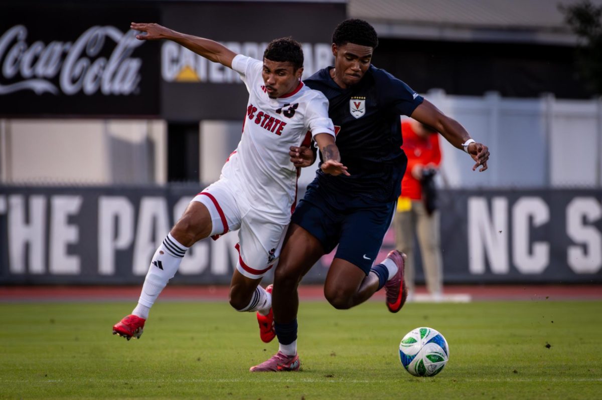 Senior defender Calem Tommy cuts in front of Virginia forward Nicholas Simmonds during the game in Dail Soccer Stadium on Sunday, Oct. 5, 2025. The Cavaliers defeated the Wolfpack 1-0.