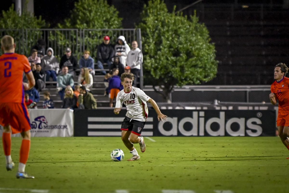 Senior midfielder Taig Healy drives the ball during the match against Clemson at Dail Soccer Feild. on Friday, Oct 10, 2025. Healy has offered 6 assists in the 2025 season. NC State beat Clemson 1-0.