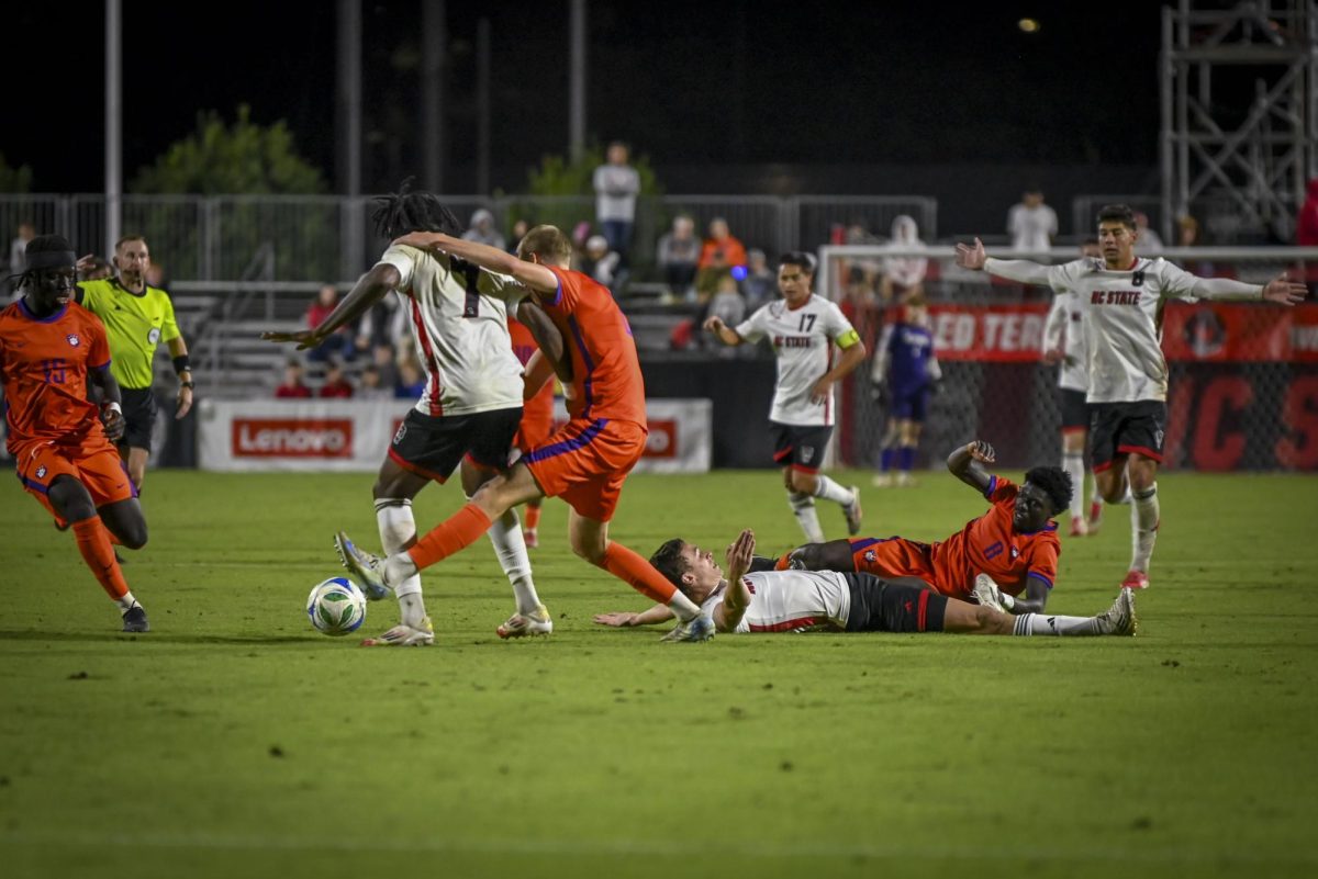 Redshirt junior forward Aiden Payne collides with an opponent during the match against Clemson at Dail Soccer Field. on Friday, Oct 10, 2025. NC State beat Clemson 1-0.
