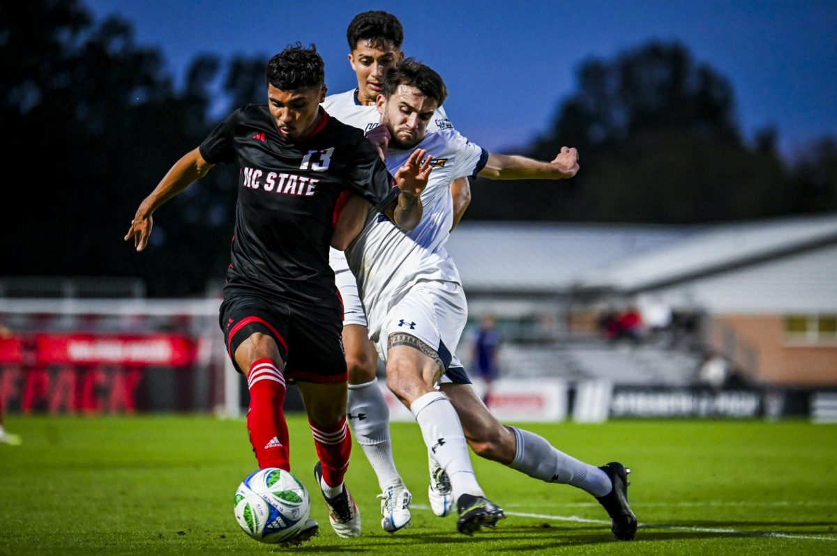 Senior defender Calem Tommy battles opponents for the ball during the match versus UNCG at Dail Soccer Field  on Tuesday, Oct. 21, 2025. NC State tied the match 1-1 with UNCG.