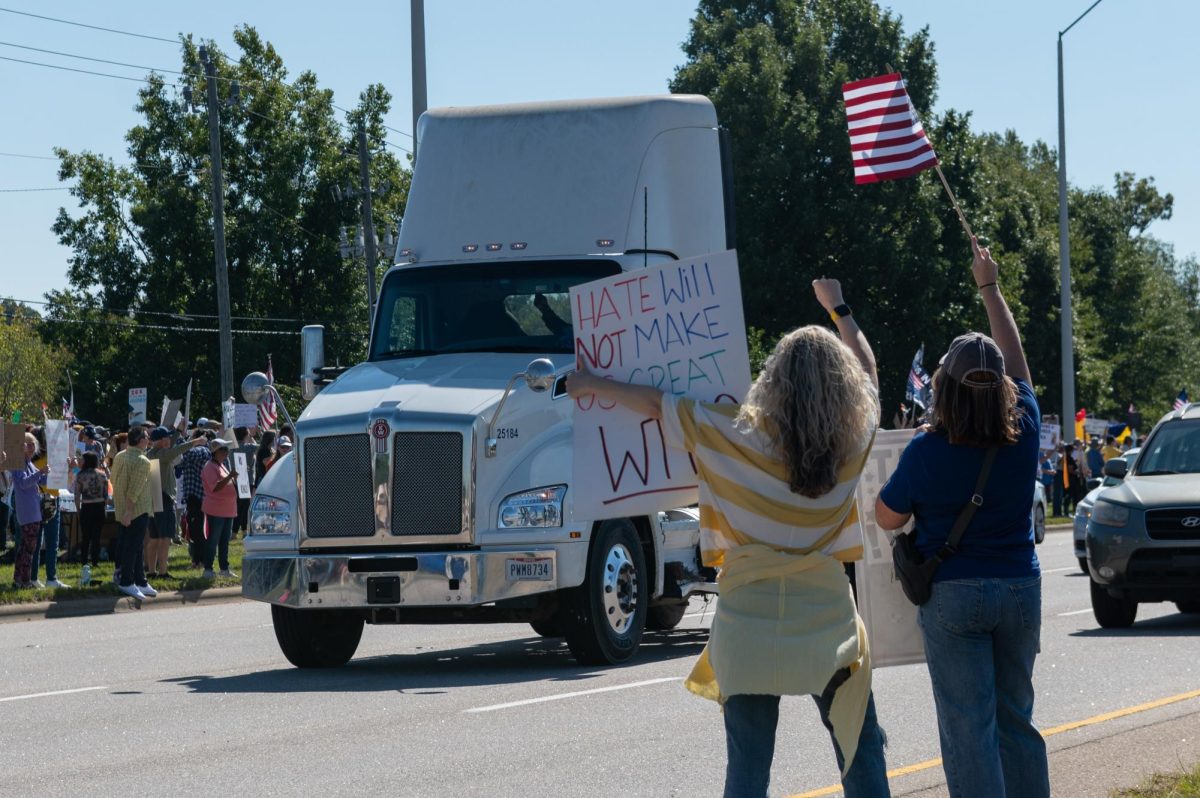 Protesters cheer as a semi-truck driver honks his horn in support during the No Kings protest on Capital Boulevard in Raleigh, NC, on Saturday, Oct. 18, 2025. The nationwide No Kings protests were organized in response to the recent policies and actions of President Donald Trump’s administration.