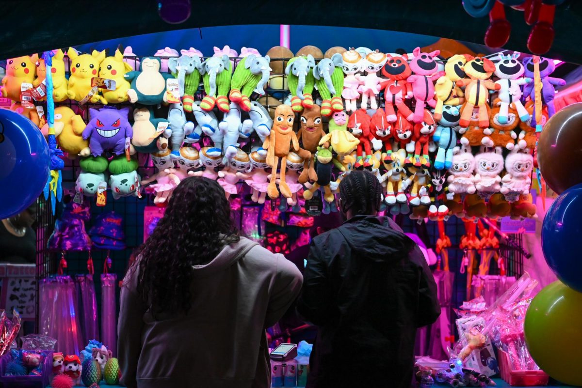Destiny Lawson and Antwan Rogers from greensboro browse for prizes during the North Carolina State Fair on Oct. 22, 2025. The N.C State Fair brings together visitors for rides, food, and exhibits.