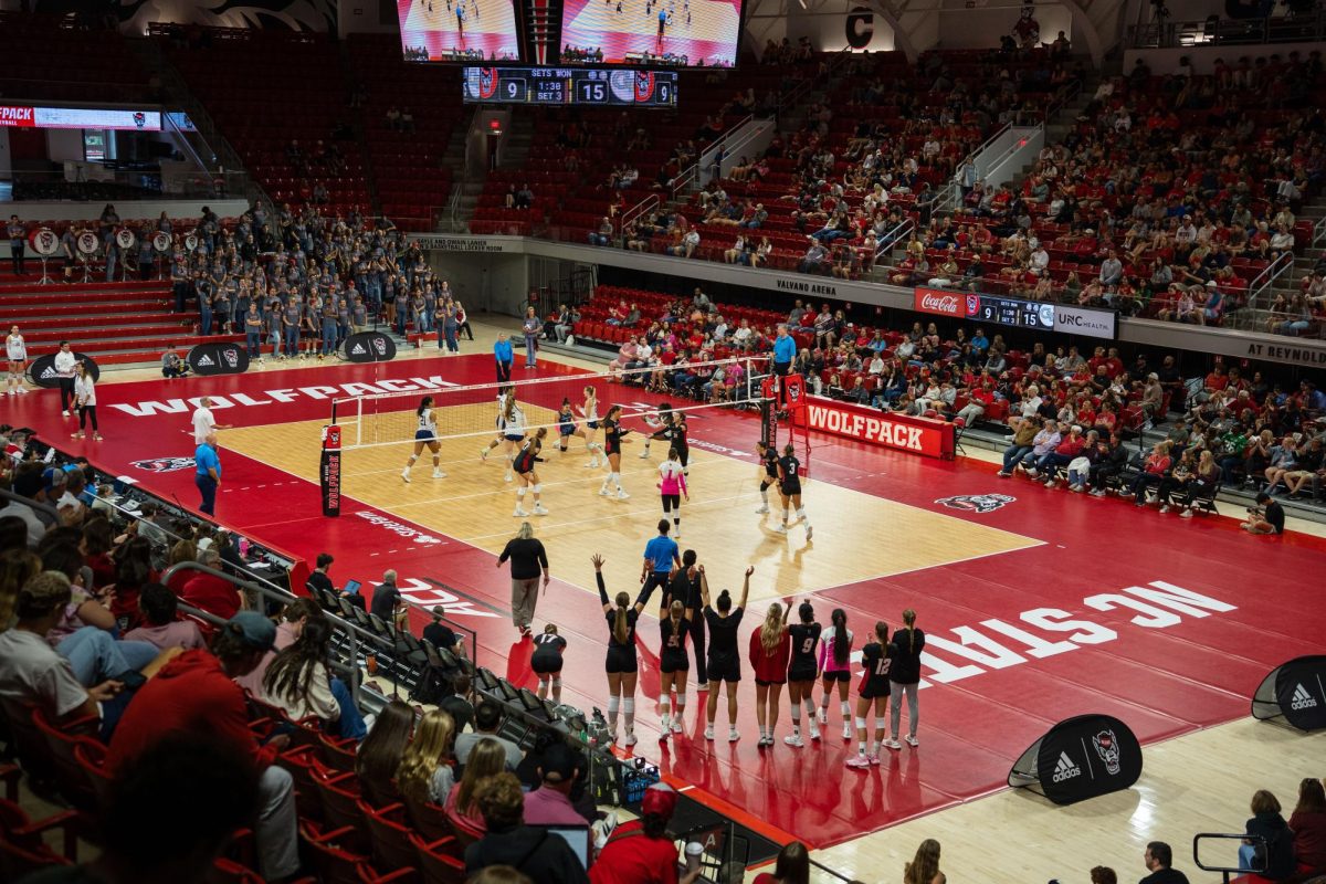 NC State women’s volleyball team celebrates as the crowd watches after scoring a point during the game against Georgia Tech in Reynolds Coliseum on Sunday, Oct. 19, 2025. NC State lost to Georgia Tech 0-3.