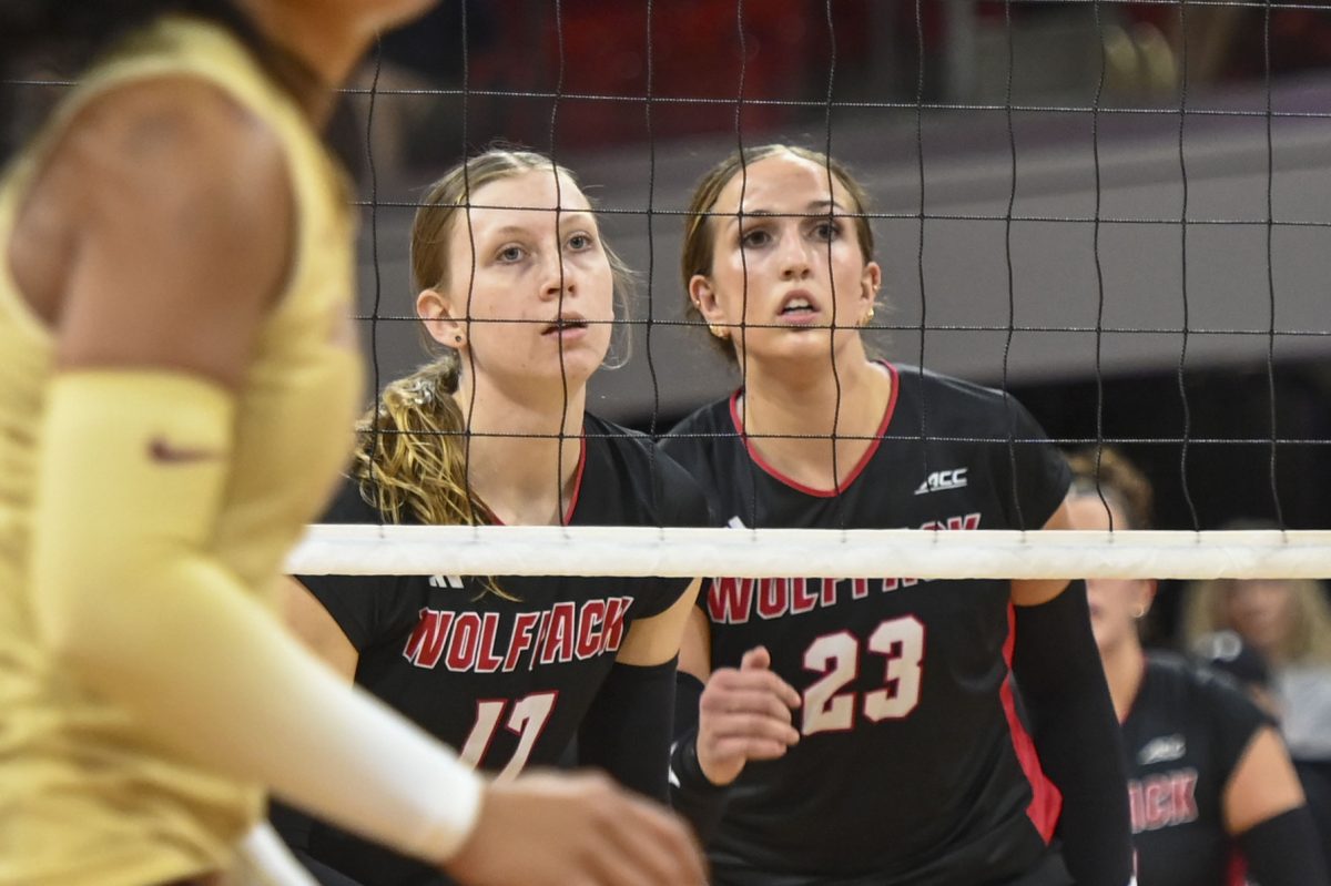 Freshman middle blocker Talia Francom and freshman opposite hitter Jordan Smith watch as the opposing team returns the spike during the game against Florida State at Reynolds Coliseum on Sunday, Oct. 5, 2025. Francom and Smith got seven combined kills. NC State beat Florida State 3-2.