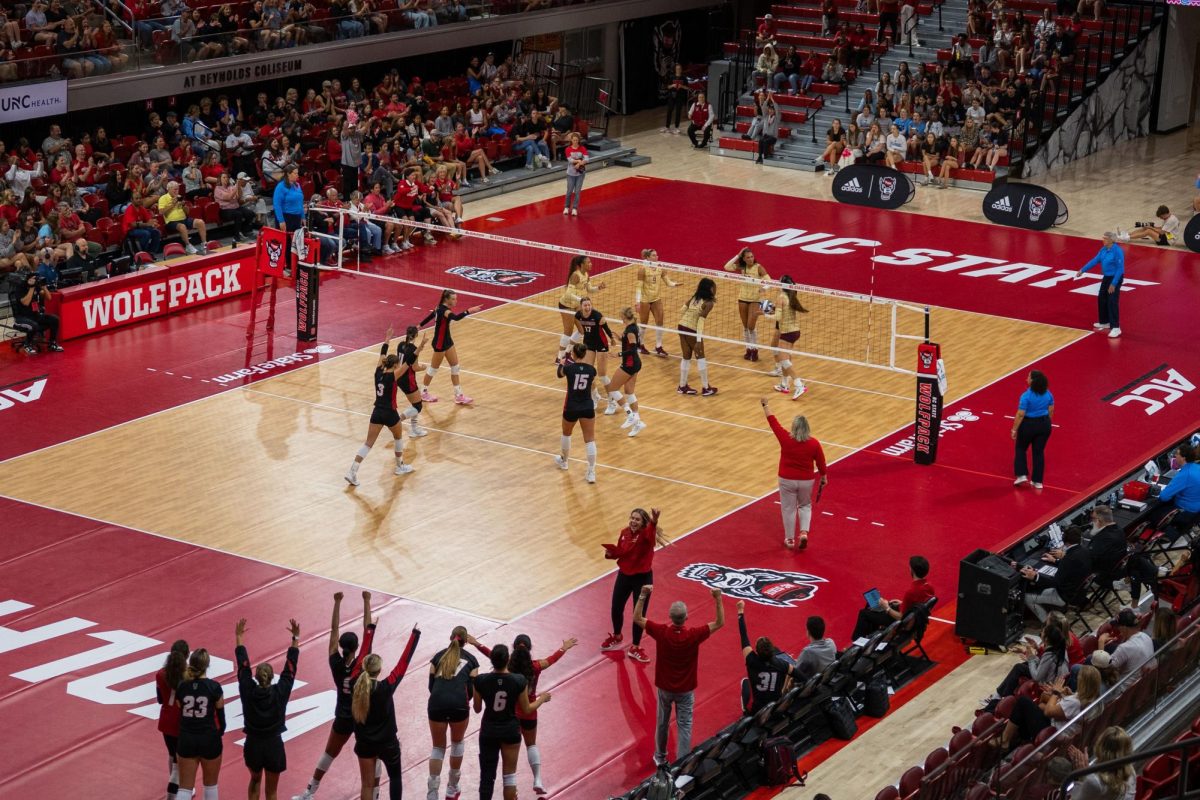 NC State women’s volleyball team celebrates with the crowd during the game against Florida State at Reynolds Coliseum on Sunday, Oct. 5, 2025. The Wolfpack got 58 kills. NC State beat Florida State 3-2.