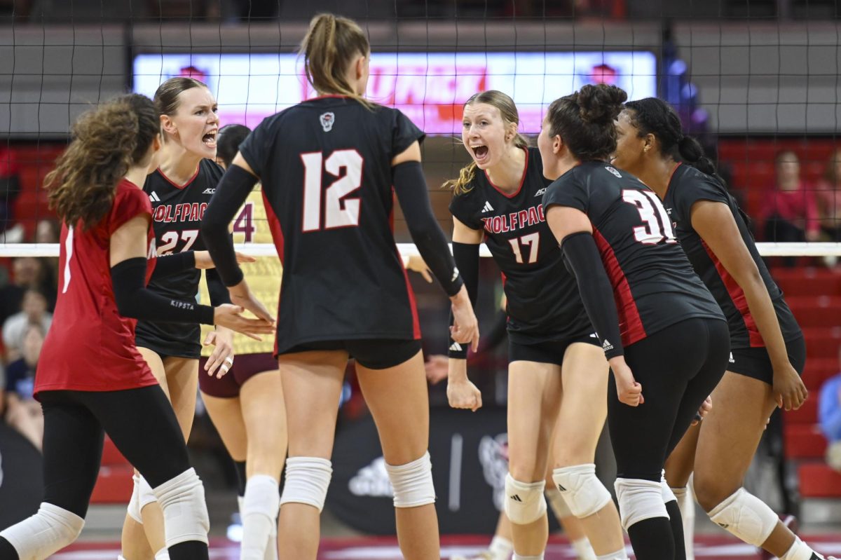 NC State women’s volleyball team celebrates after scoring a point during the game against Florida State at Reynolds Coliseum on Sunday, Oct. 5, 2025. The Wolfpack got 58 kills. NC State beat Florida State 3-2.