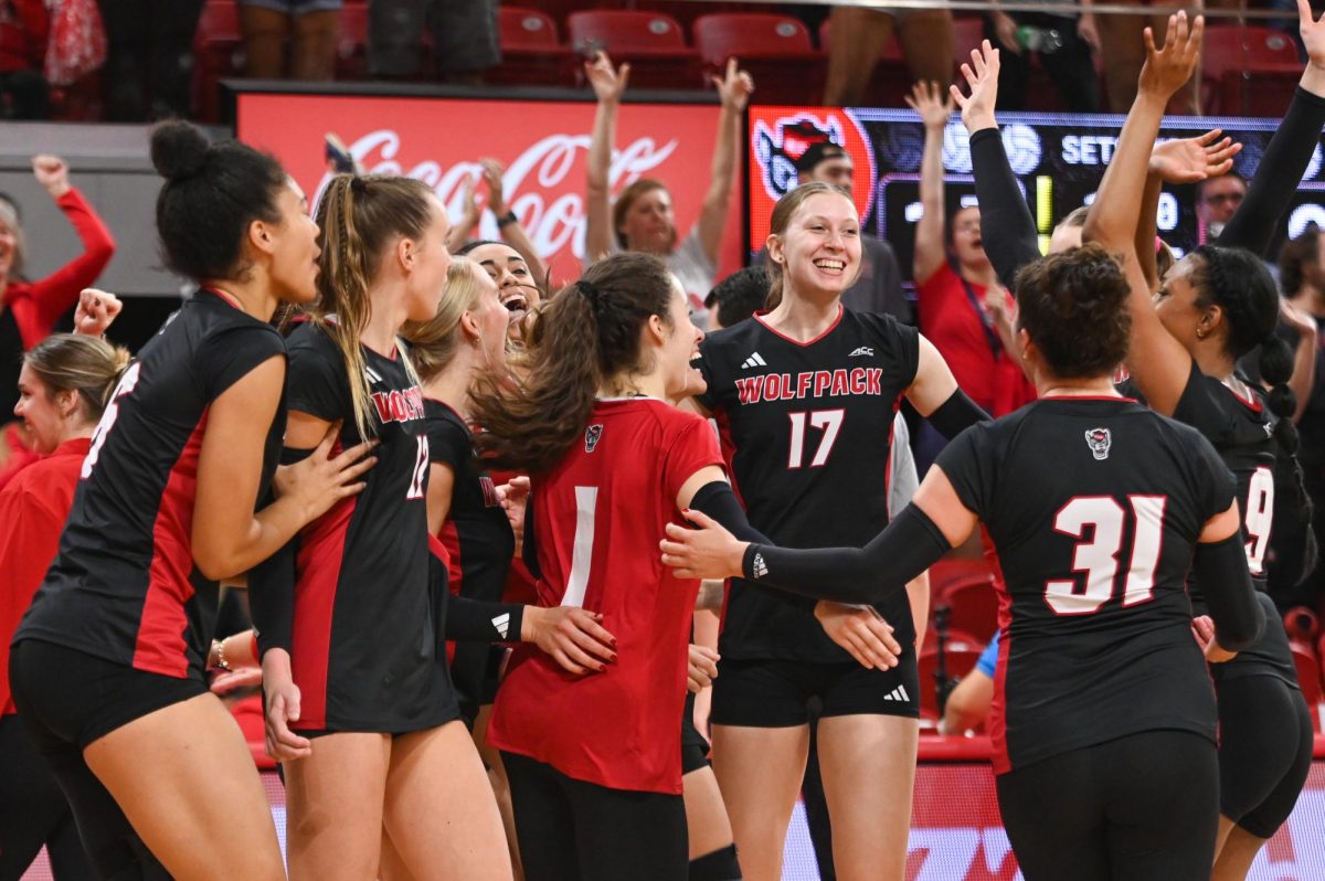 NC State team celebrates after the game against Florida State at Reynolds Coliseum on Sunday, Oct. 5, 2025. The wolfpack scored a total of 77 points. NC State beat Florida State 3-2.