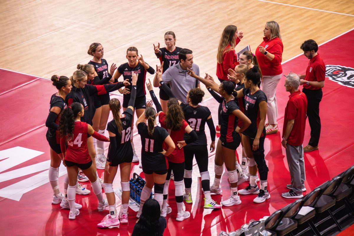 NC State women’s volleyball team in a huddle during the game against Florida State at Reynolds Coliseum on Sunday, Oct. 5, 2025. NC State beat Florida State 3-2.