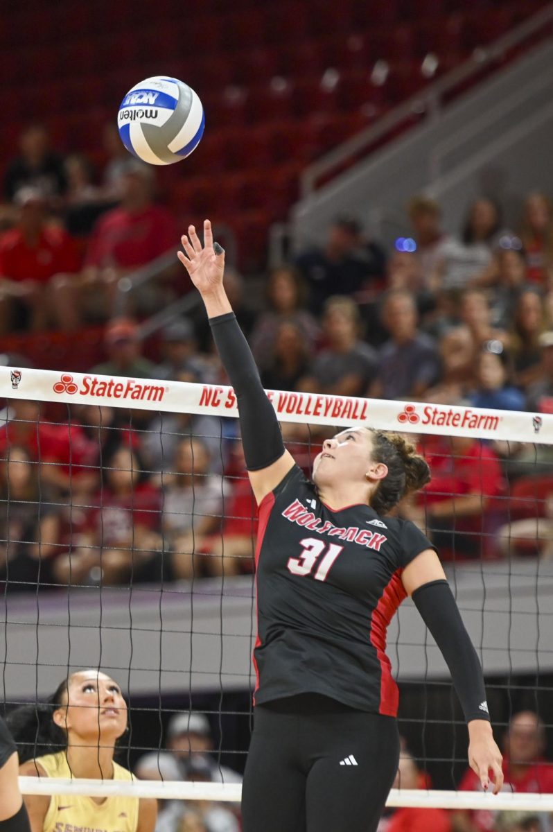 Junior defensive specialist Elaisa Villar jumping up to keep the ball in play during the game against Florida State at Reynolds Coliseum on Sunday, Oct. 5, 2025. Villar had 34 set assists. NC State beat Florida State 3-2.