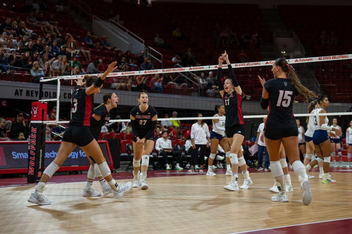NC State women’s volleyball team celebrates after scoring a point during the game against Georgia Tech in Reynolds Coliseum on Sunday, Oct. 19, 2025. NC State lost to Georgia Tech 0-3.