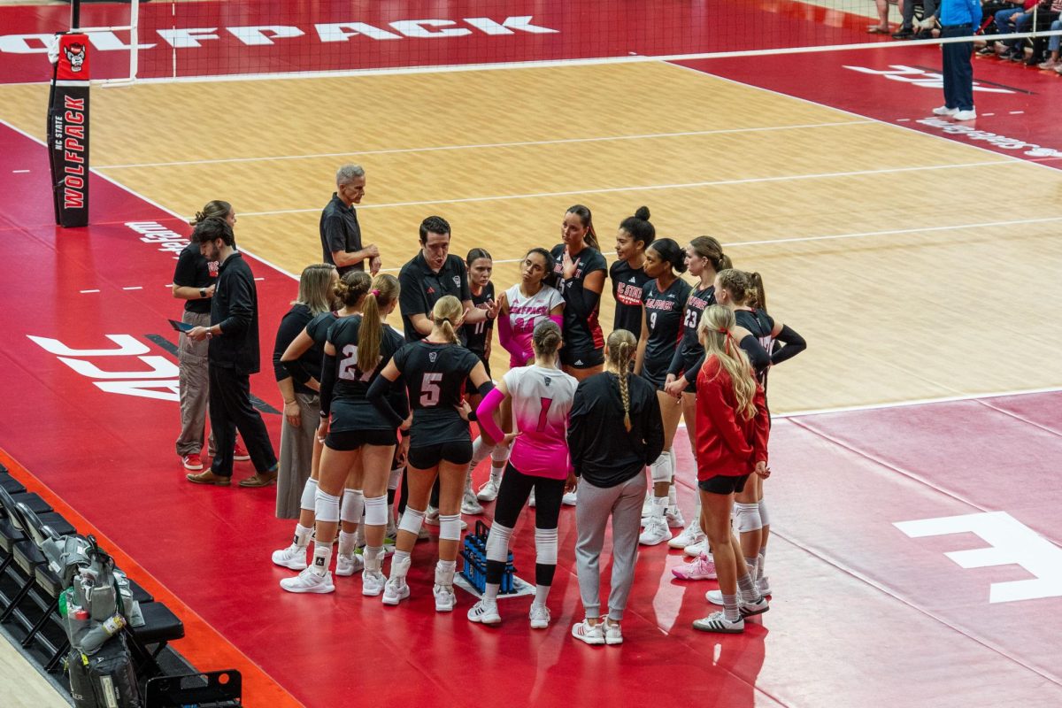 NC State women’s volleyball team huddles during the game against Georgia Tech in Reynolds Coliseum on Sunday, Oct. 19, 2025. NC State lost to Georgia Tech 0-3.