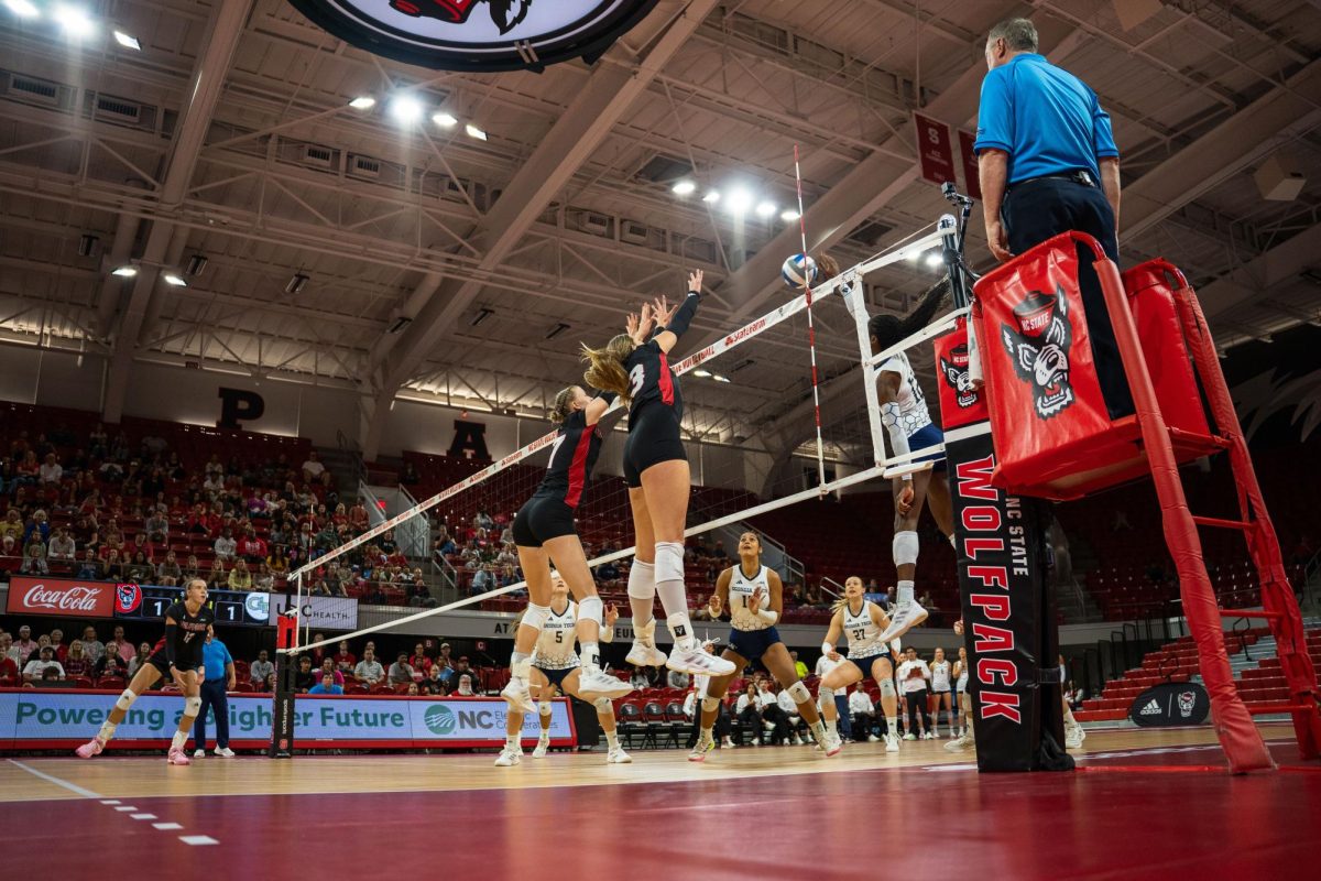 Freshman opposite Jordan Smith and freshman middle blocker Talia Francom jump to block the ball during the game against Georgia Tech in Reynolds Coliseum on Sunday, Oct. 19, 2025. NC State lost to Georgia Tech 0-3.
