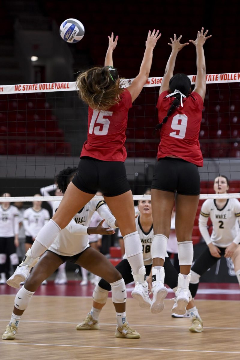 Senior middle blocker Lily Cropper and freshman opposite hitter Sa'Mya Dorsey go to block the ball during the match against Wake Forest at Reynolds Coliseum on Saturday, Oct. 11, 2025. NC State beat Wake Forest 3-1.