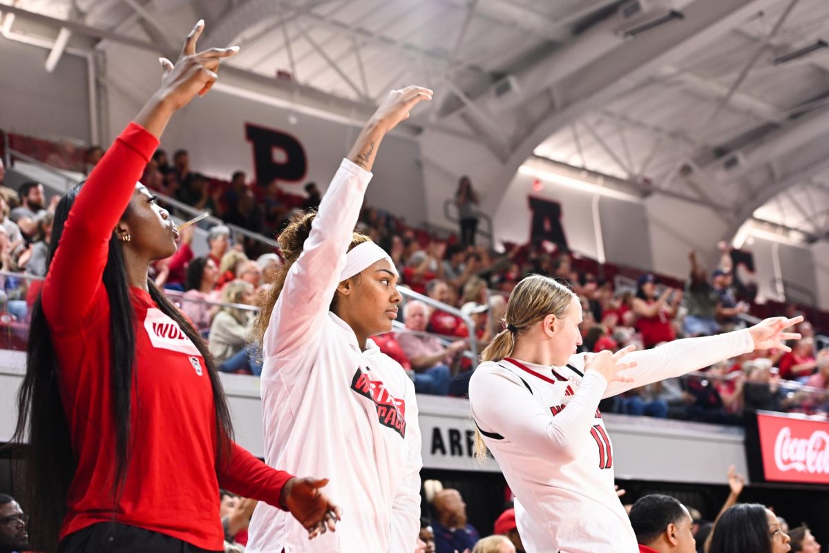 Sophomore center Lorena Awou, junior center Mallory Collier and junior forward Maddie Cox celebrate a 3-pointer during the exhibition against High Point on Saturday, Oct. 18, 2025. The Wolfpack made seven 3-pointers. The Wolfpack beat the Panthers 77-69.