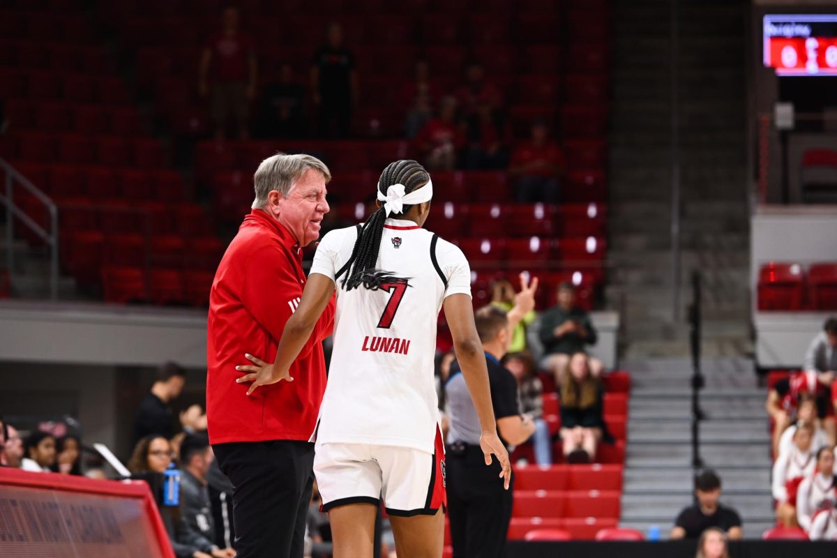 Head coach Wes Moore talks to freshman guard Destiny "Ky'She" Lunan during the exhibition against High Point on Saturday, Oct. 18, 2025. The Wolfpack beat the Panthers 77-69.