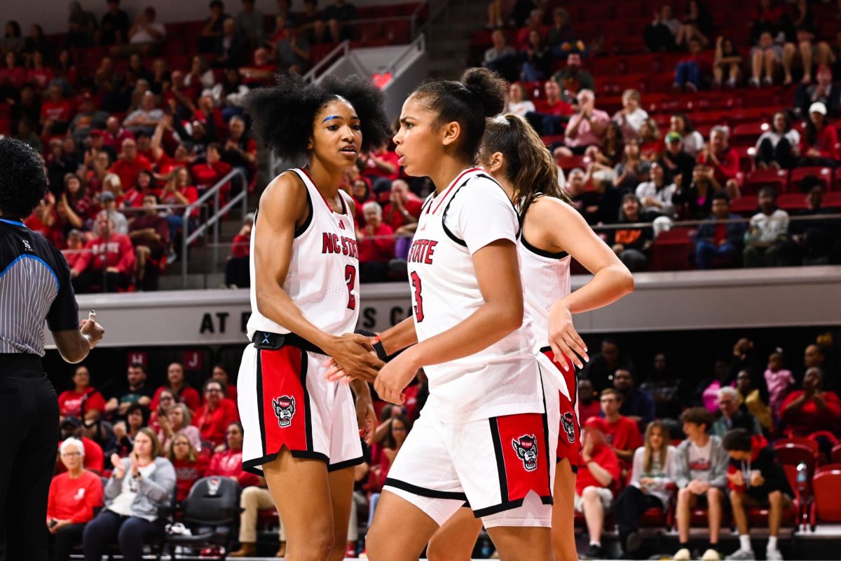 Junior guard Qadence Samuels high-fives sophomore guard Zamareya Jones during the exhibition against High Point on Saturday, Oct. 18, 2025. Samuels made eight rebounds and scored 14 points. The Wolfpack beat the Panthers 77-69.