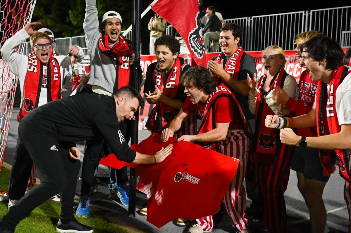 Head coach Gary Higgins stamps a billboard with the Red Terrors after the game against Wake Forest in Dail Soccer Stadium on Thursday, Oct. 2, 2025. The Wolfpack defeated the Demon Deacons 2-1.