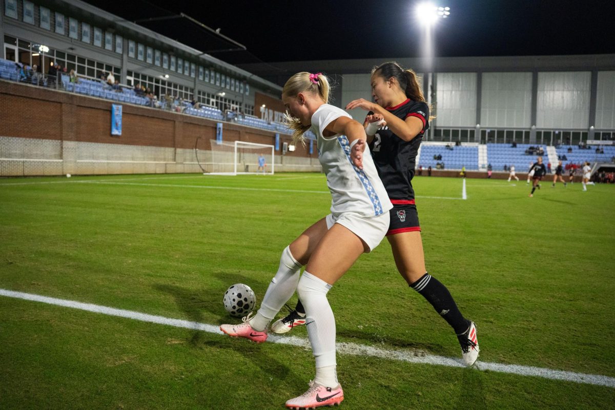 Junior defender Yuna Aoki tries to keep the ball in bounds during the game against UNC in Dorrance Field on Thursday, Oct. 30, 2025. NC State lost to UNC 1-0.