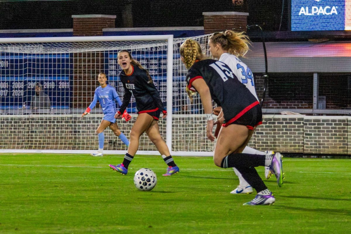 Freshman forward Daisy Duda watches her opponent dribble during the game against UNC in Dorrance Field on Thursday, Oct. 30, 2025. NC State lost to UNC 1-0.