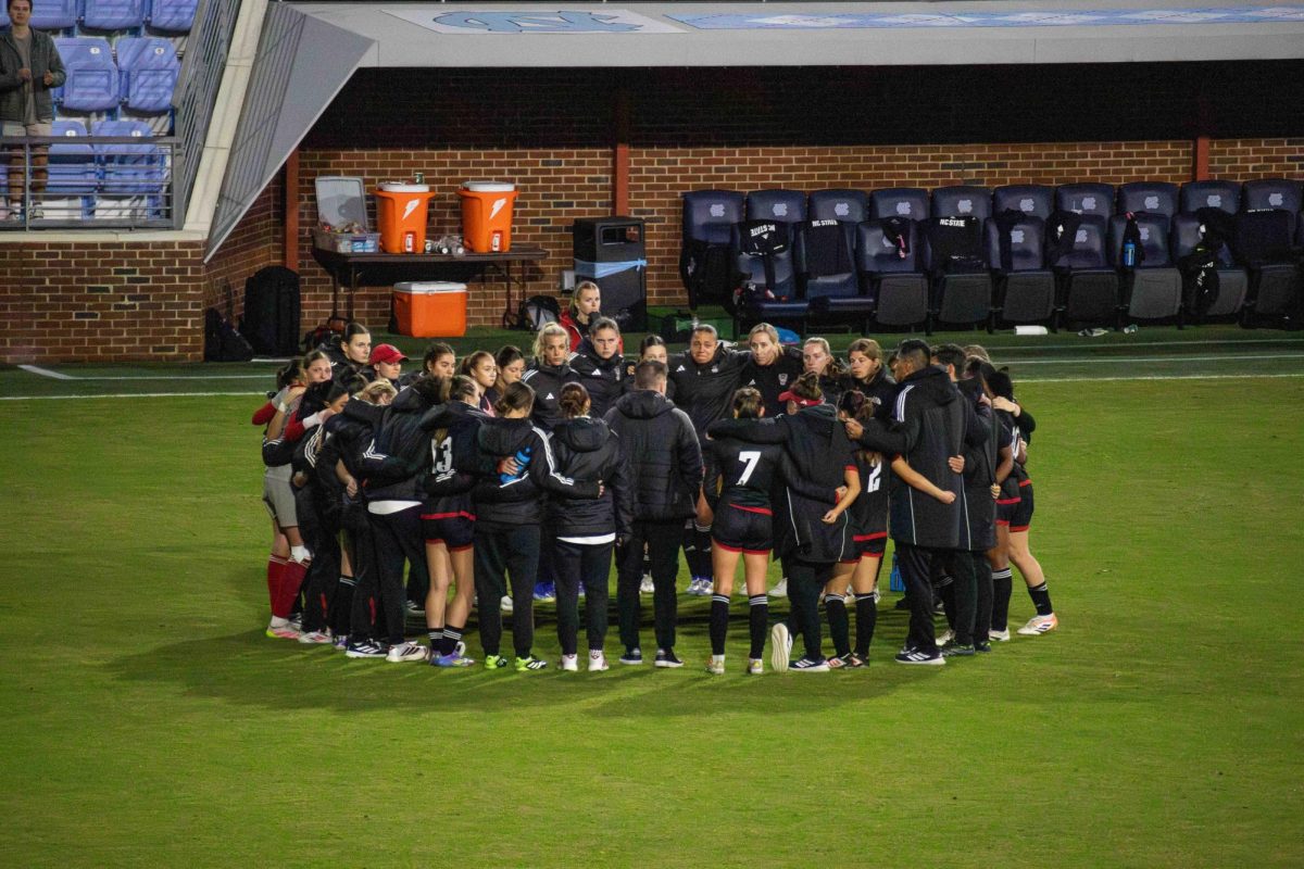 The NC State women's soccer team huddles after the game against UNC at Dorrance Field on Thursday, Oct. 30, 2025. NC State lost to UNC 1-0.