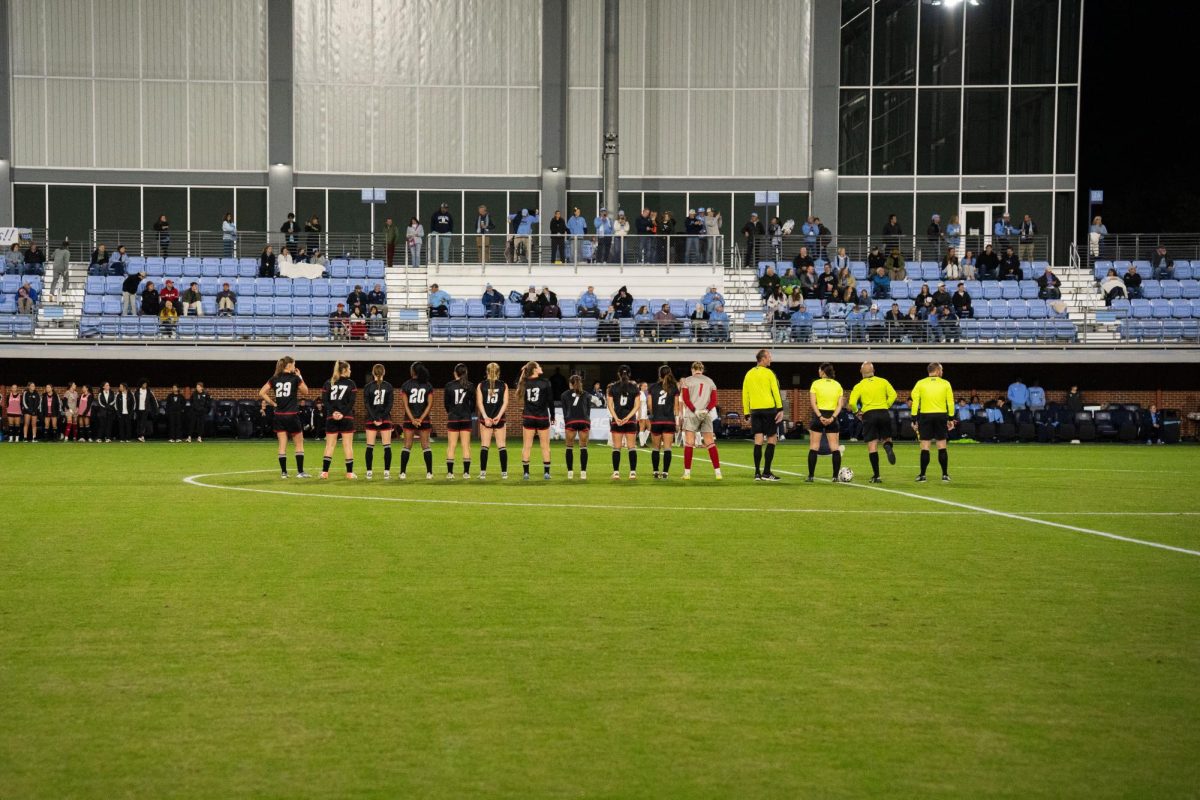 The NC State women's soccer team stands together before the game against UNC in Dorrance Field on Thursday, Oct. 30, 2025. NC State lost to UNC 0-1.