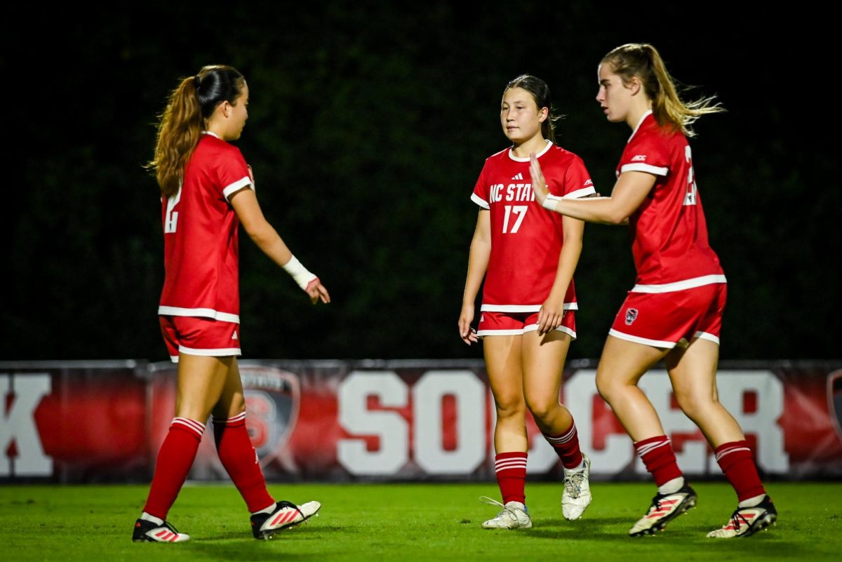 Junior defender Mackenize Smith high fives Junior defender Yuna Aoki during the game against Wake Forest in Dail Soccer Stadium on Thursday. Oct. 2, 2025. The Wolfpack beat the Demon Deacons 2-1. 