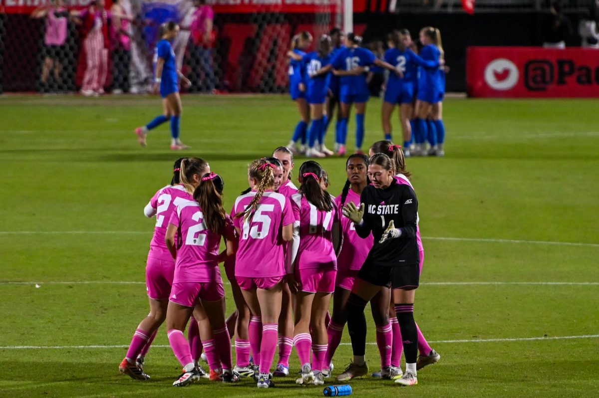The Wolfpack breaks its huddle before the game at Dail Soccer Field on Sunday, Oct. 26, 2025. The Blue Devils defeated the Wolfpack 3-1.