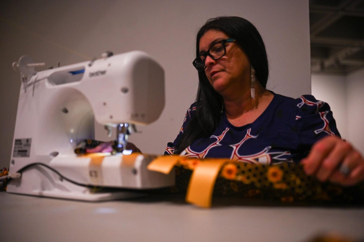 Norma Jean uses a sewing machine to create during the 30th Annual American Indian Heritage Celebration at the North Carolina Museum of Art on Saturday, Nov. 22, 2025. Vendors were demonstrating their crafts while in the east building of the museum.