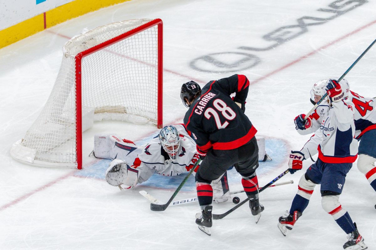 Left wing William Carrier scrambles for the puck during the game against the Washington Capitals at the Lenovo Center on Tuesday, Nov. 11, 2025. Carrier had zero shots on goal. The Capitals beat the Canes 4-1.