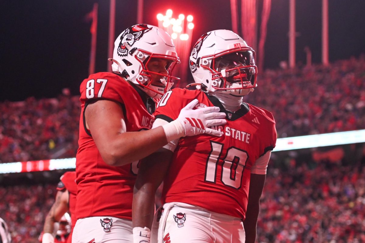 Redshirt senior tight end Dante Daniels and freshman quarterback Will Wilson celebrates a touchdown during the game against UNC-Chapel Hill at Carter-Finley Stadium on Saturday, Nov. 29, 2025. Wilson scored a total of four touchdowns. NC State beat UNC 42-19.