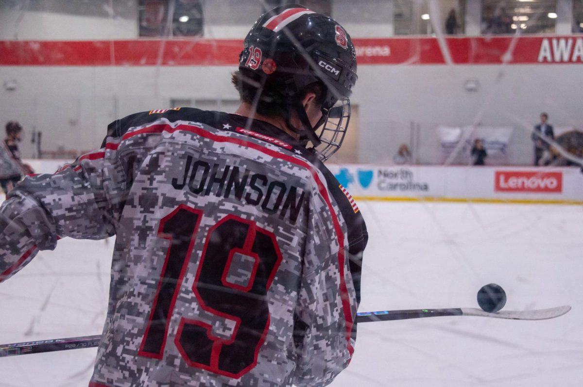Sophomore forward Reece Johnson juggles a puck to warm up before the game at Invisalign Arena on Friday, Nov. 14,  2025. NC State defeated Alabama 4-3.