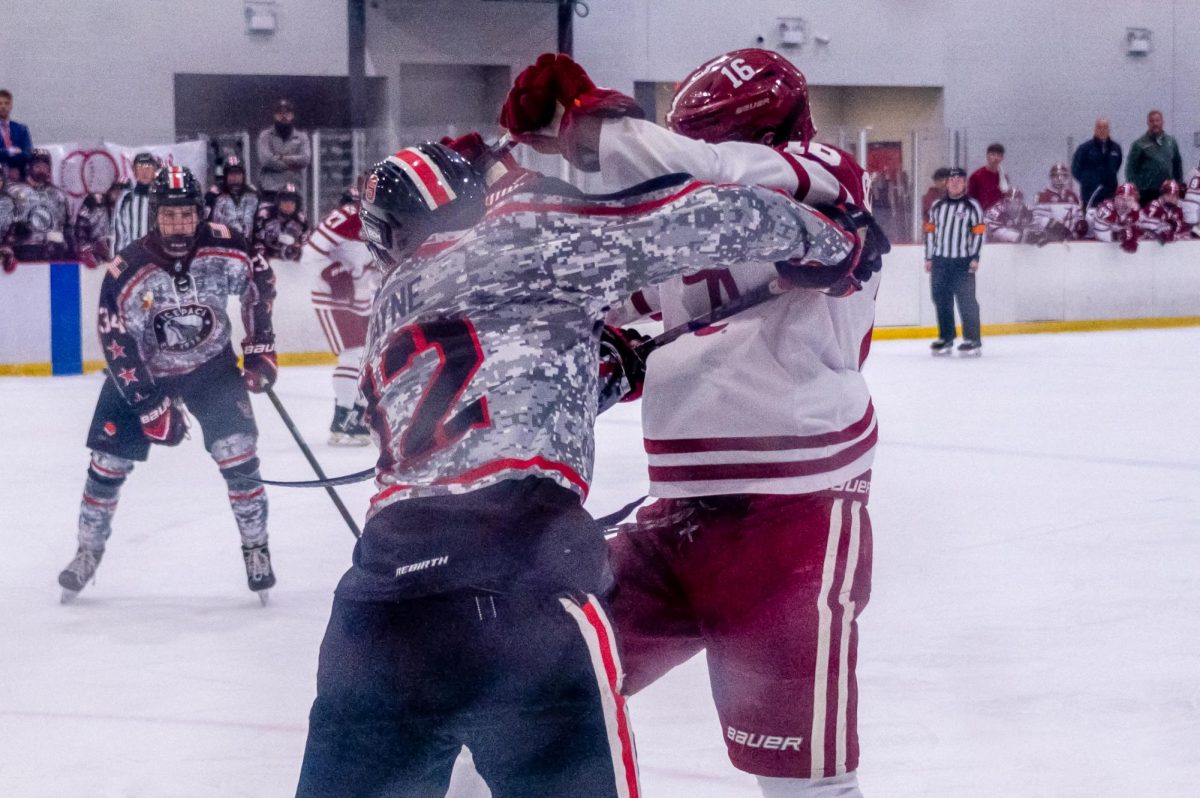 Freshman defenseman Mason Payne tussles with his opponent during the game at Invisalign Arena on Friday, Nov. 14,  2025. NC State defeated Alabama 4-3.