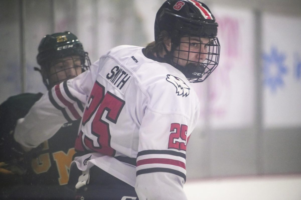 Freshman defenseman Cam Smith pushes back an opponent during the game against George Mason at Invisalign Arena on Friday, Nov. 21, 2025. Smith has played in 7 games this season. NC State lost to George Mason 3-1.