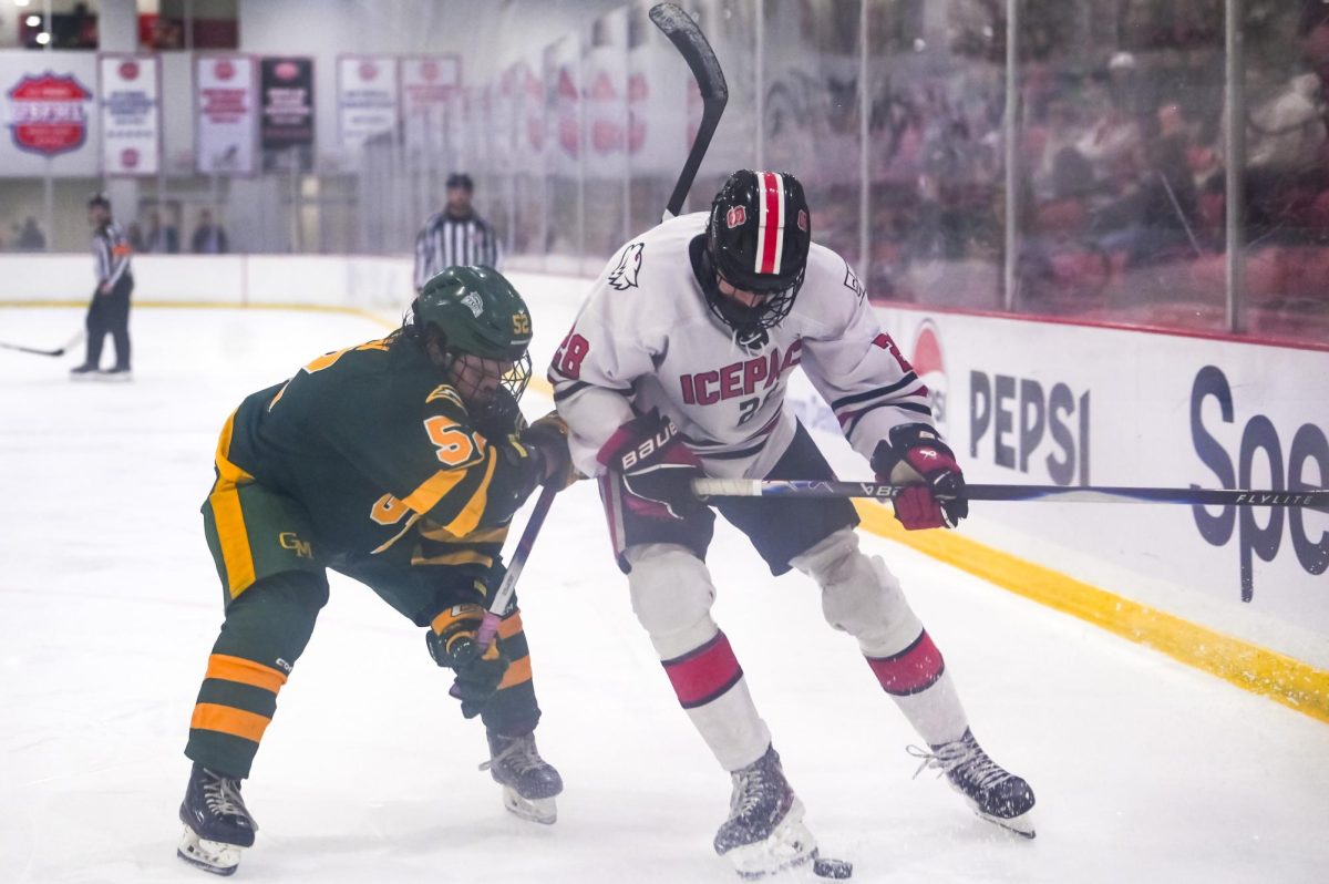 Sophomore forward Jake Gifford fights for possession during the game against George Mason at Invisalign Arena on Friday, Nov. 21, 2025. Gifford has had 5 goals this season. NC State lost to George Mason 3-1.