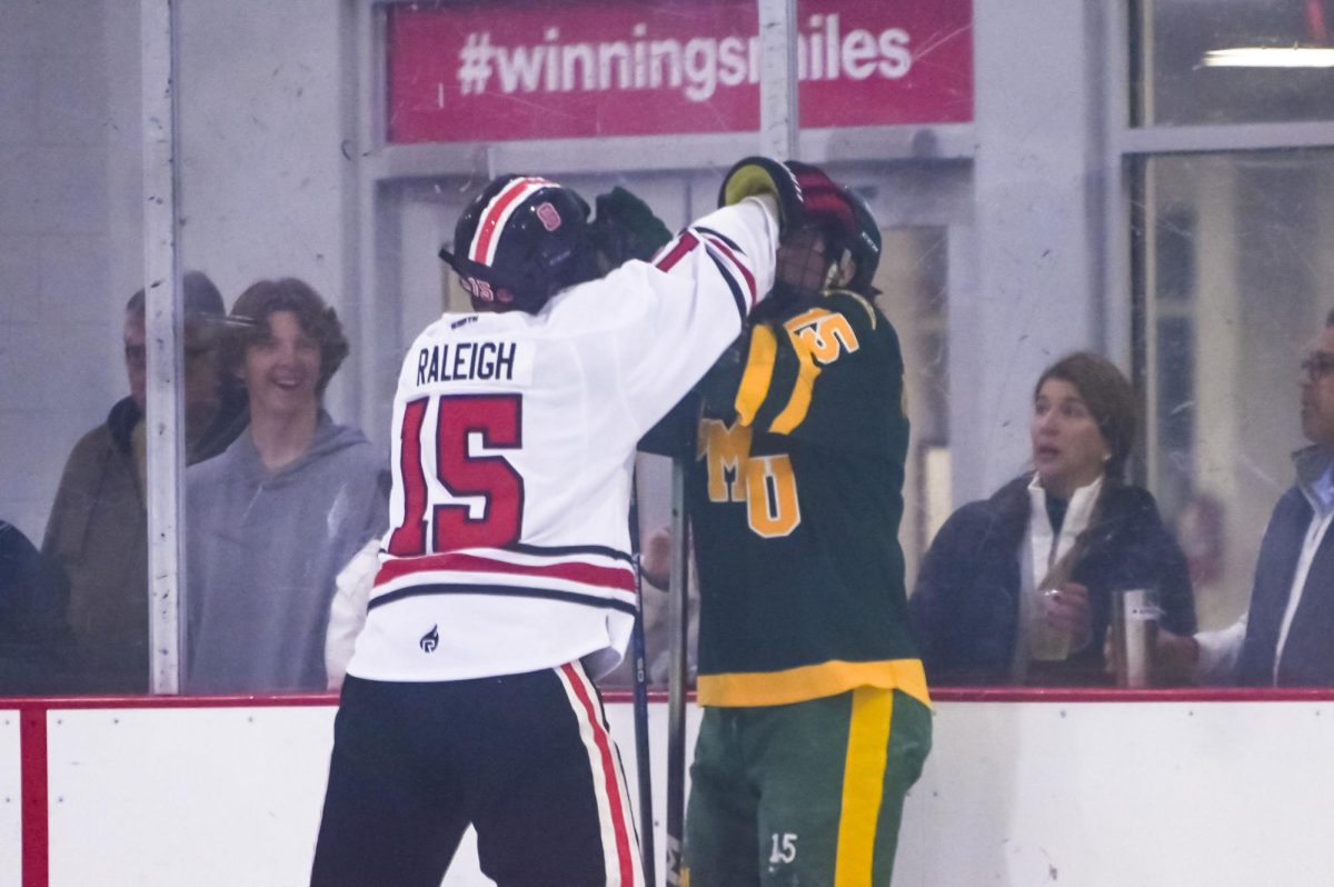 Freshman forward Brandon Raleigh skirmishes against an opponent during the game against George Mason at Invisalign Arena on Friday, Nov. 21, 2025. Raleigh has played in 7 games this season. NC State lost to George Mason 3-1.