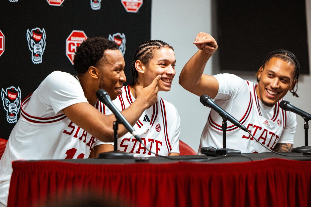 Senior guard Quadir Copeland and senior forward Darrion Williams point at freshman guard Matt Able as he smiles during the post-game press conference after the game against NC Central at Lenovo Center on Monday, Nov. 3, 2025. NC State beat NC Central 114-66.