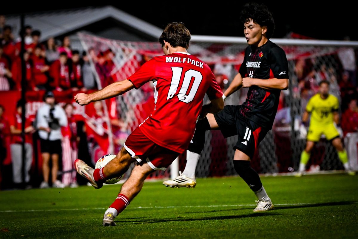 Senior midfielder Taig Healy kicks the ball during the game against Louisville at Dail Soccer Stadium on Wednesday, Nov. 24, 2025. The Wolfpack defeated the Cardinals 3-0. 