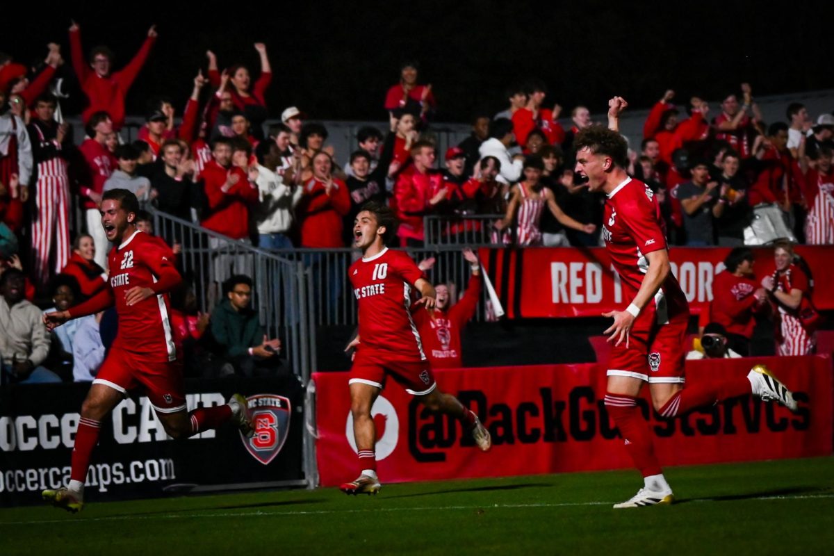 Senior midfielder Drew Lovelace, Midfielder Senior Taig Healy, and Defense Freshman Riley Monolney celebrate after the first goal during the game against Louisville at Dail Soccer Stadium on Wednesday, Nov. 24, 2025. The Wolfpack defeated the Cardinals 3-0. 