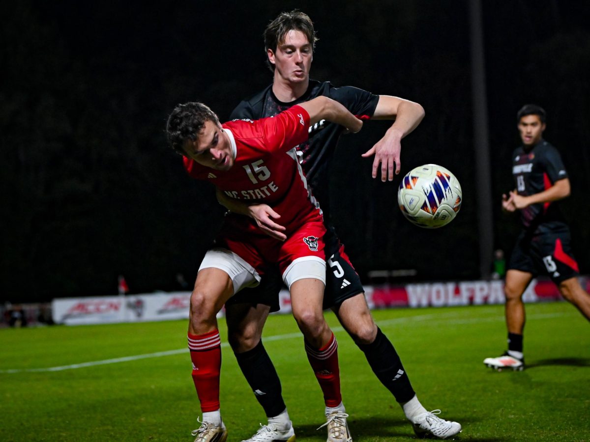 Junior Forward Aidan Payne fights for the ball during the game against Louisville at Dail Soccer Stadium on Wednesday, Nov. 24, 2025. The Wolfpack defeated the Cardinals 3-0. 