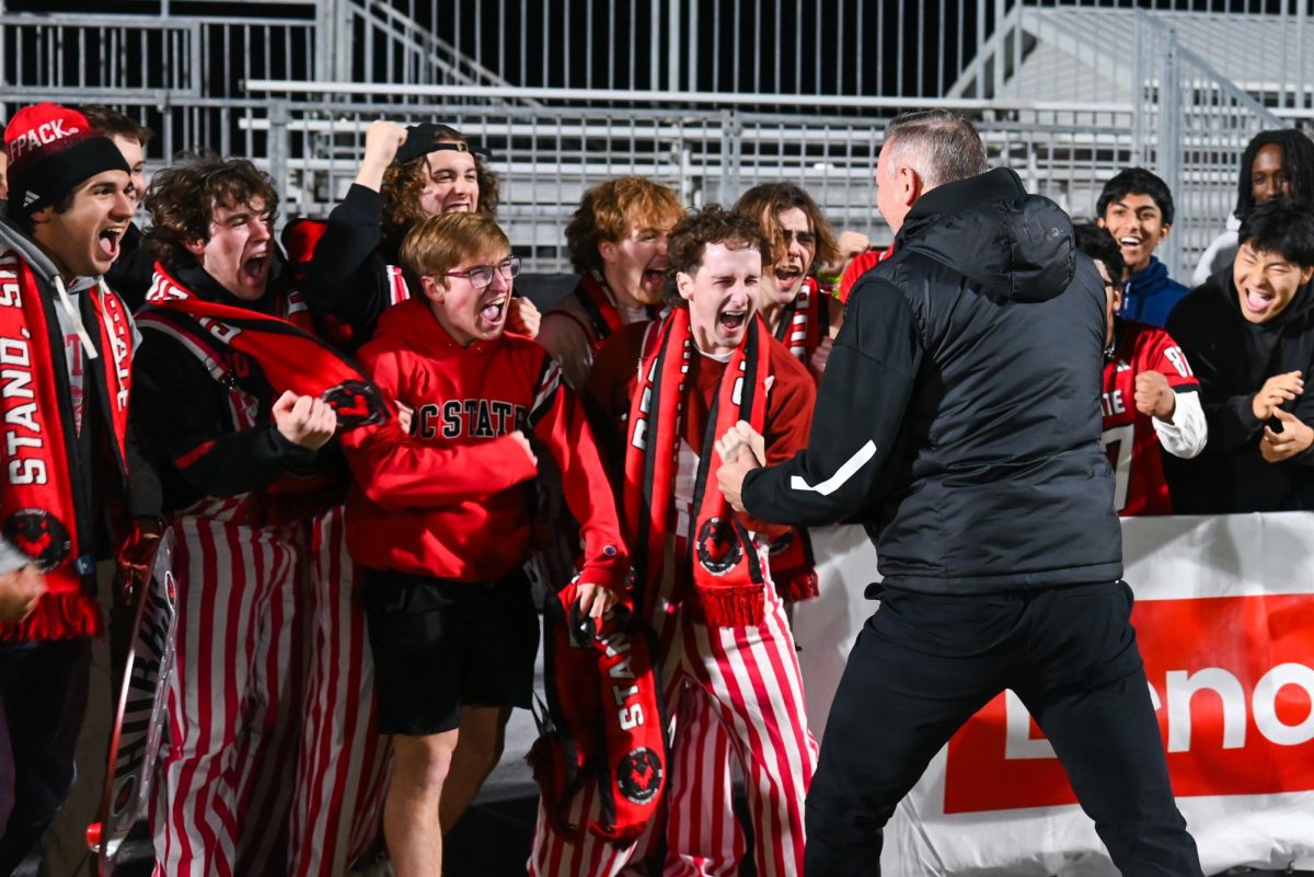 Students of The Red Terrors celebrate with Head Coach Marc Hubbard after the game against Marshall University at Dail Soccer Field on Sunday, Nov 23, 2025. NC State is moving into the Sweet Sixteen after defeating Marshall University 2-0.