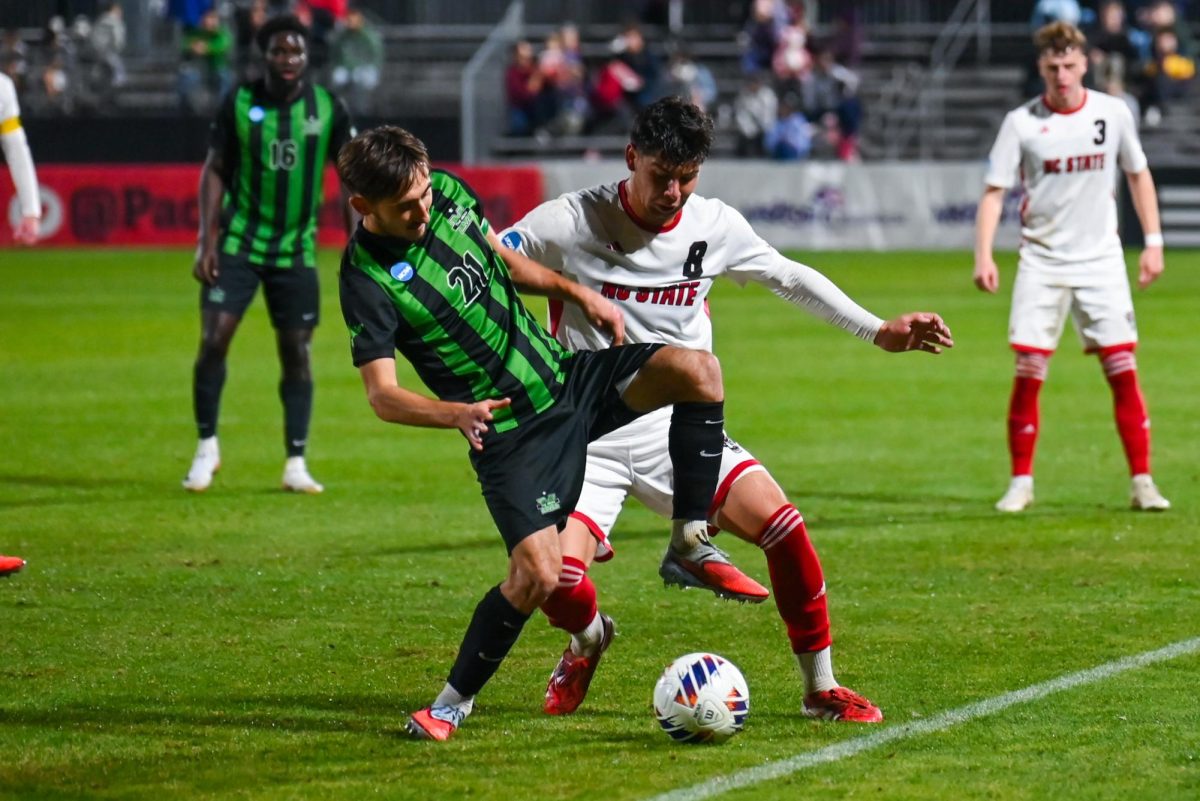 Senior midfielder Justin Mclean pressures his opponent during the match against Marshall University at Dail Soccer Field on Sunday, Nov 23, 2025. Mclean had 2 total shots and played for 68 minutes of the game. NC State beat Marshall University 2-0.