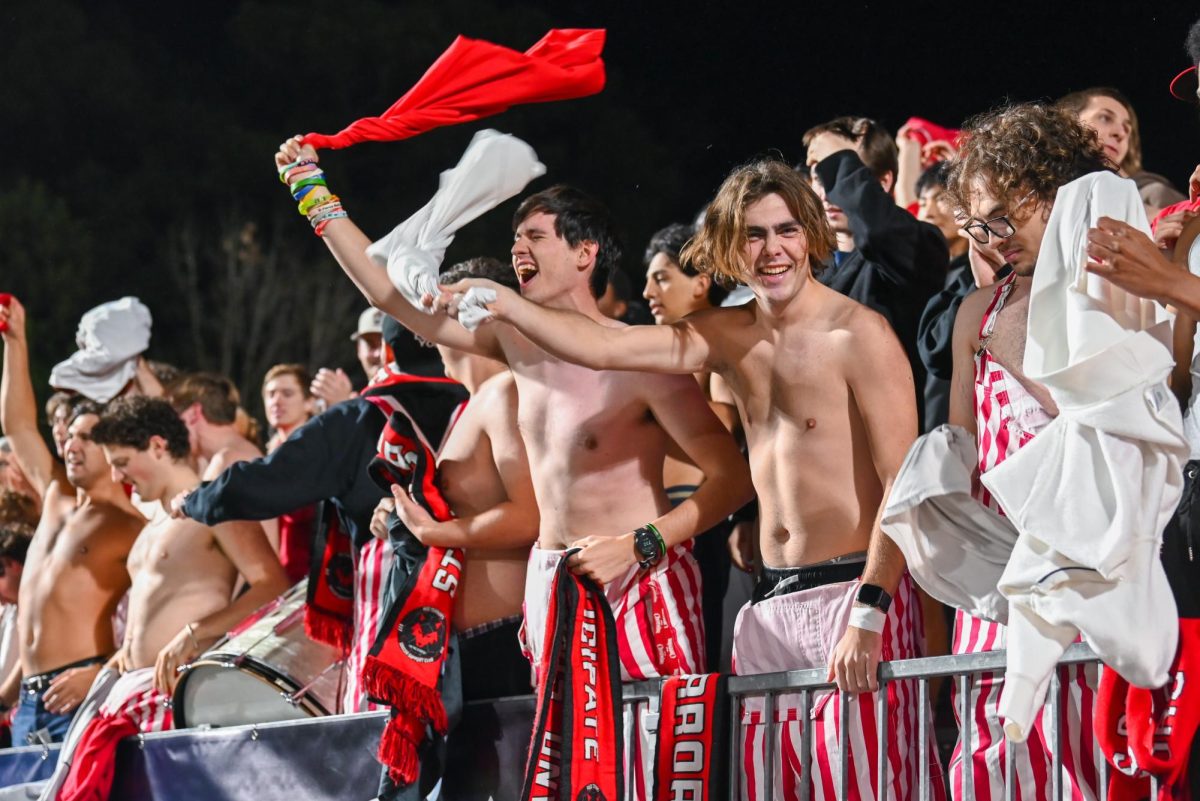 Students of The Red Terrors twirl their shirts around in celebration of being up 2-0 against Marshall University at Dail Soccer Field on Sunday, Nov 23, 2025. NC State scored their first goal within the first 2 minutes of the game. NC State beat Marshall University 2-0.