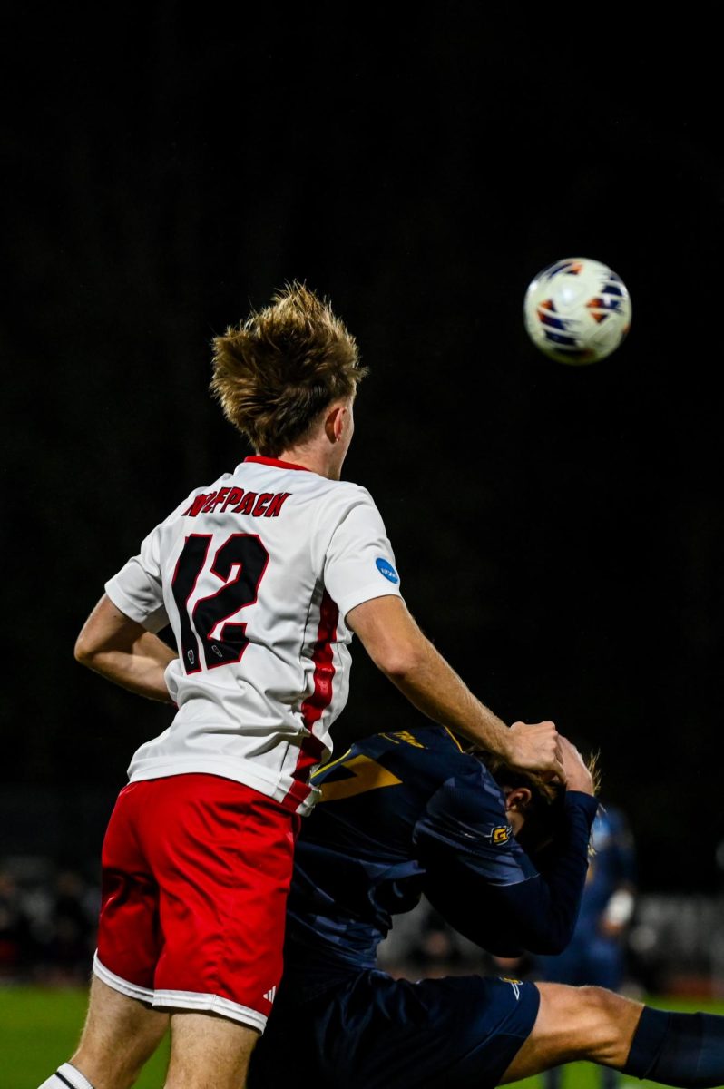 Junior midfielder Tyler Caton heads the ball during the game against UNCG in Dail Soccer Stadium on Sunday, Nov. 30, 2025. The Wolfpack defeated the Spartans 2-0.