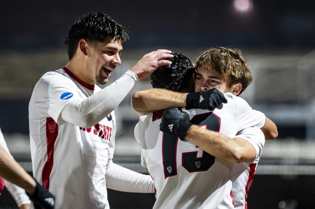 Senior midfielder Taig Healy hugs senior defender Calem Tommy while celebrating after a goal during the game against UNCG at Dail Soccer Stadium on Sunday, Nov. 30, 2025. The Wolfpack defeated the Spartans 2-0.